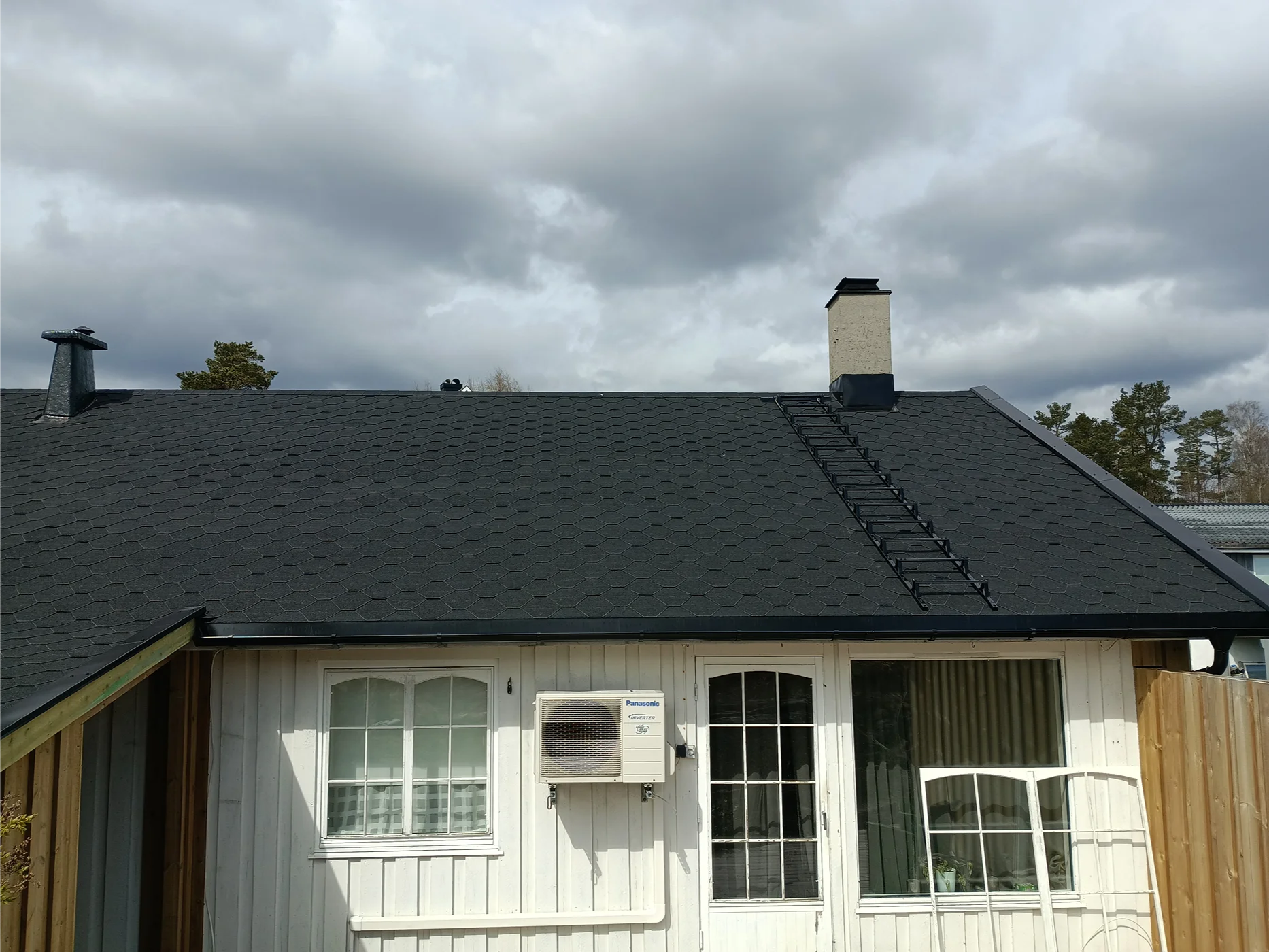 Modern roof renovation with dark gray shingles