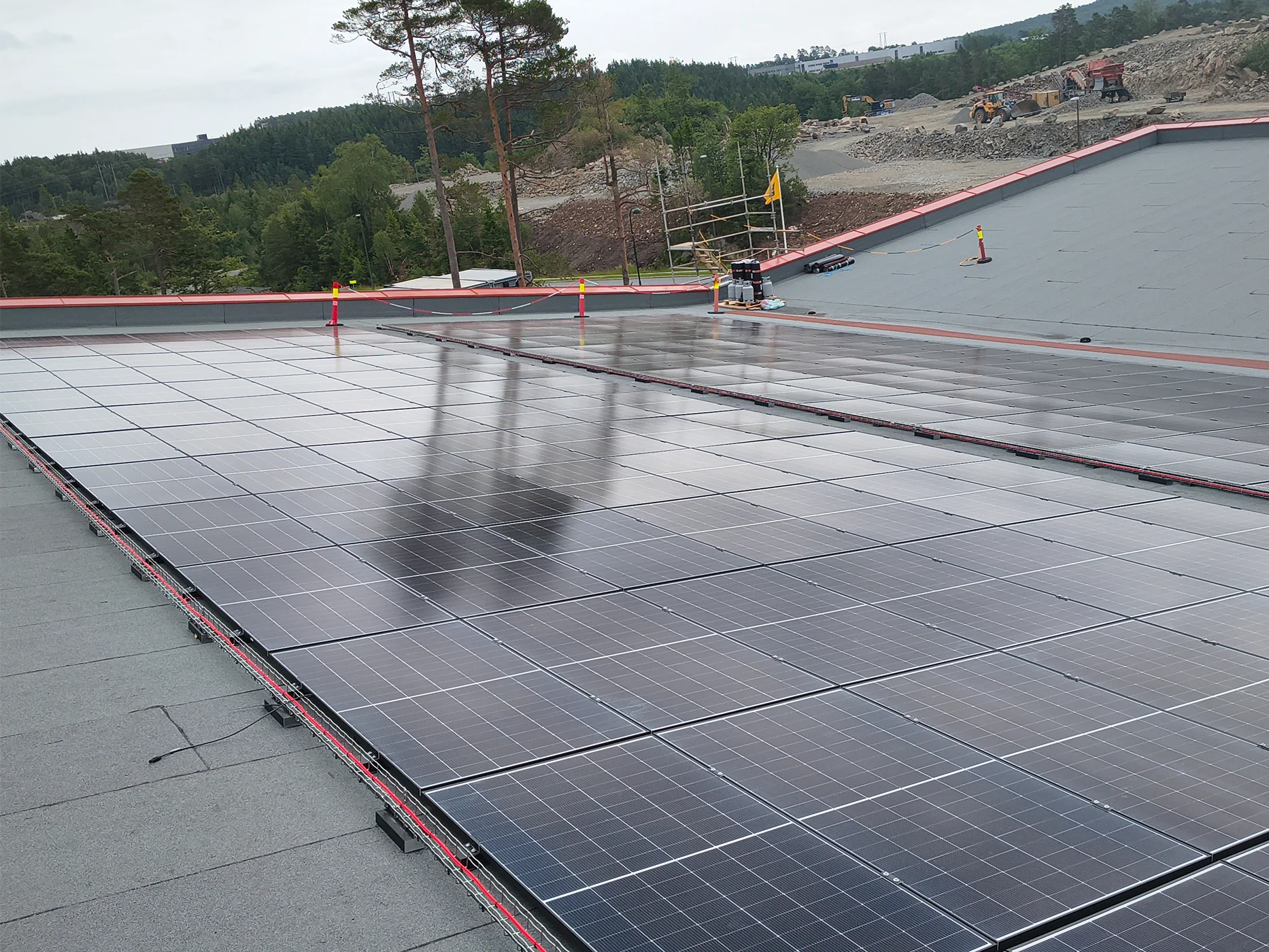 Geomembrane installation with red containment barriers