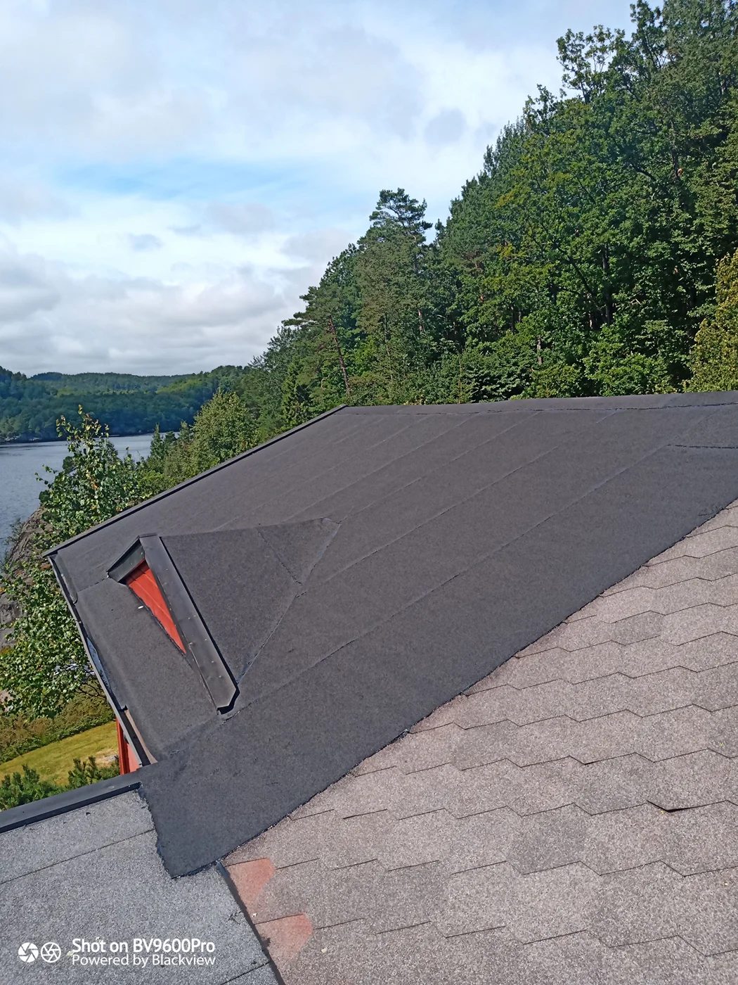 Roofing membrane installation overlooking forest lake